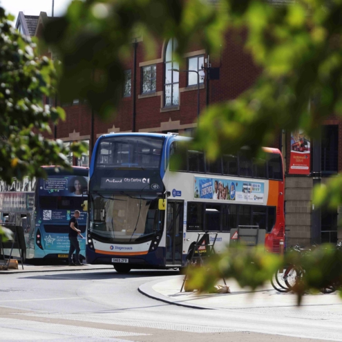 A bus moving through a city. Greener ways to travel.